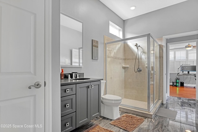 bathroom featuring vanity, ceiling fan, and a shower with shower door