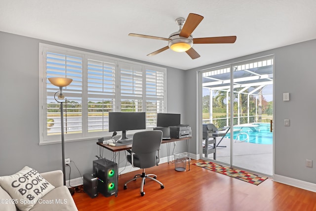 office area with hardwood / wood-style flooring and ceiling fan