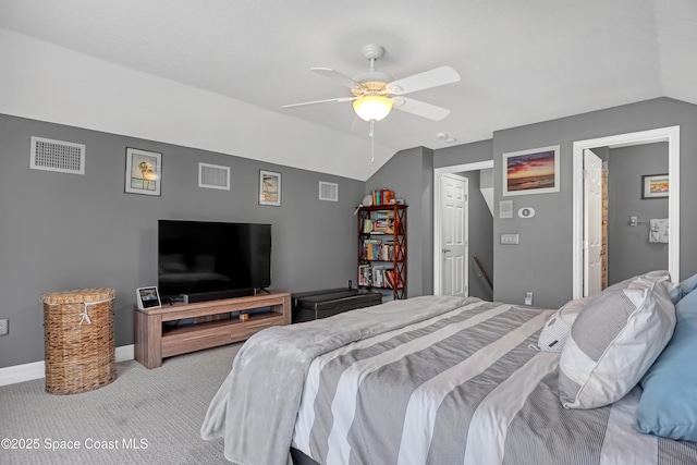 carpeted bedroom with ensuite bathroom, ceiling fan, and lofted ceiling