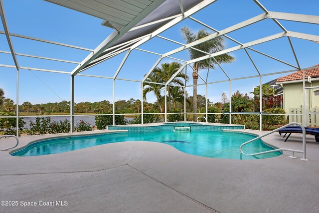 view of pool featuring a patio area, a lanai, and a water view