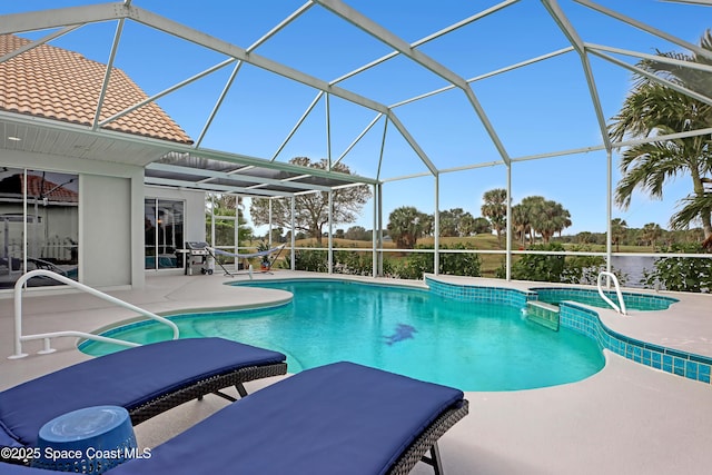 view of swimming pool featuring glass enclosure, a patio area, a water view, and grilling area