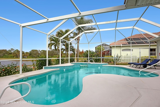 view of pool with a patio and glass enclosure