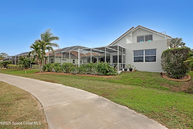 exterior space featuring a lanai and a yard