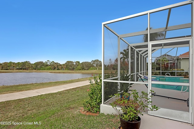 exterior space with a lanai and a water view