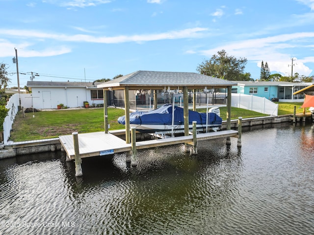 dock area featuring a water view and a yard