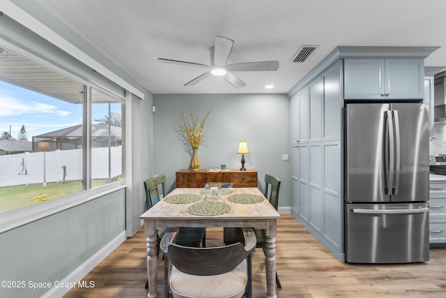 dining area featuring ceiling fan and light wood-type flooring