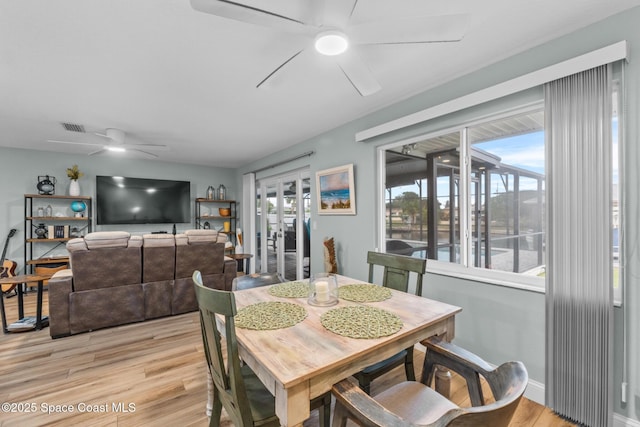 dining space featuring ceiling fan and light hardwood / wood-style floors