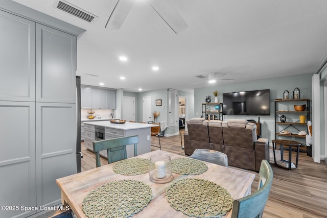 dining area featuring ceiling fan and light wood-type flooring