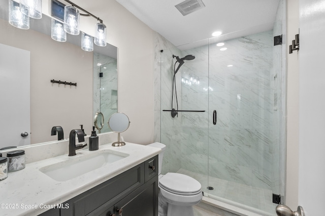 bathroom featuring toilet, vanity, and walk in shower