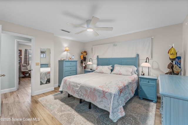 bedroom with light hardwood / wood-style flooring and ceiling fan