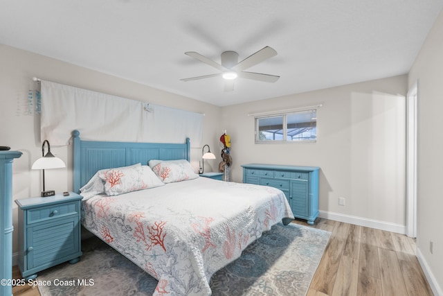 bedroom with light hardwood / wood-style flooring and ceiling fan