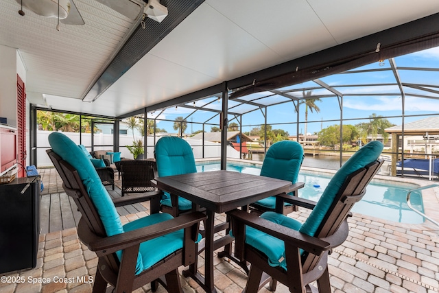 sunroom / solarium with a water view