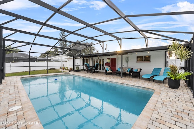 view of swimming pool featuring an outdoor living space, a patio, and glass enclosure