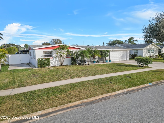 single story home featuring a garage and a front lawn