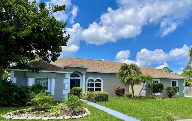 ranch-style house with a front lawn