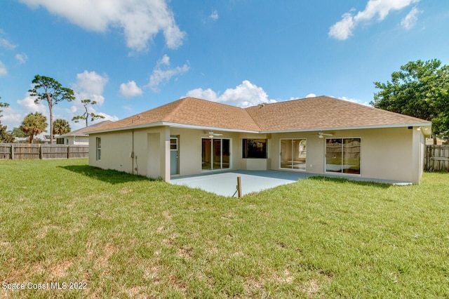 rear view of house with a yard, a patio, and ceiling fan