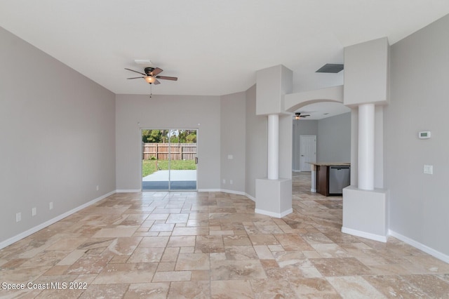 unfurnished room with ceiling fan and ornate columns