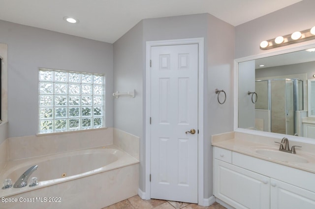 bathroom featuring vanity and separate shower and tub