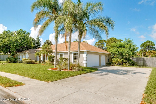 view of front of house featuring a garage and a front yard