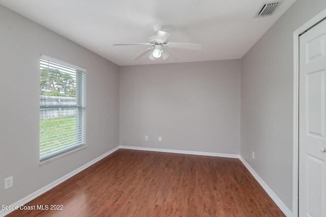 spare room with ceiling fan and dark hardwood / wood-style floors