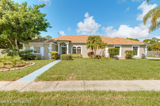 ranch-style home with a front lawn