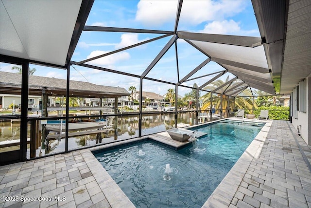 view of swimming pool featuring pool water feature, a dock, a water view, and glass enclosure