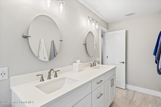 bathroom featuring vanity and a textured ceiling