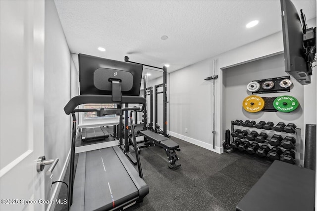 exercise area featuring a textured ceiling