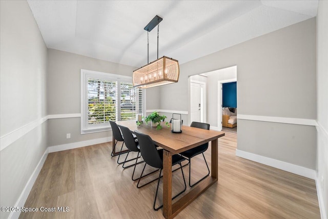 dining space with light hardwood / wood-style flooring