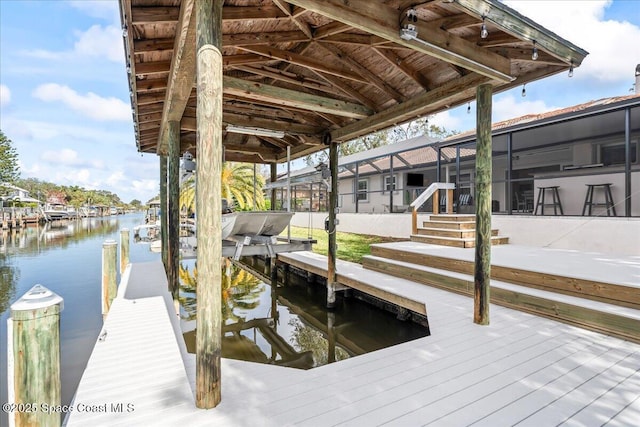 dock area with glass enclosure and a water view