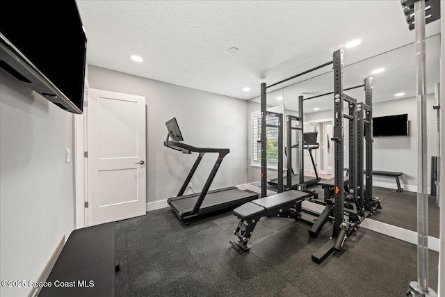 exercise room with a textured ceiling