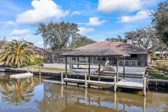 view of dock with a lanai and a water view