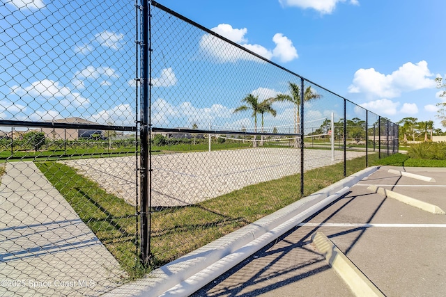 view of property's community featuring tennis court