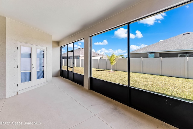 unfurnished sunroom with french doors