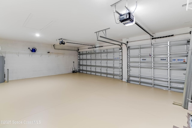 garage with electric water heater and a garage door opener