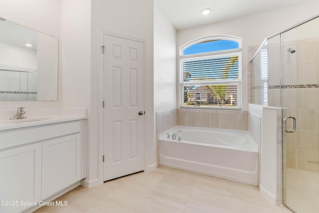 bathroom featuring tile patterned floors, vanity, and shower with separate bathtub