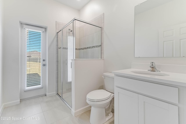 bathroom with tile patterned flooring, vanity, toilet, and a shower with shower door