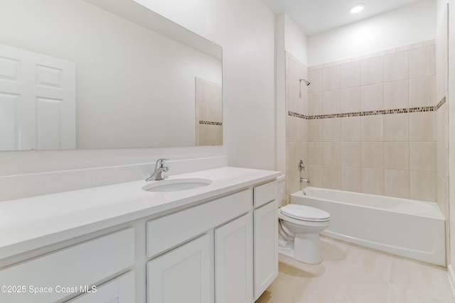 full bathroom with vanity, toilet, and tiled shower / bath