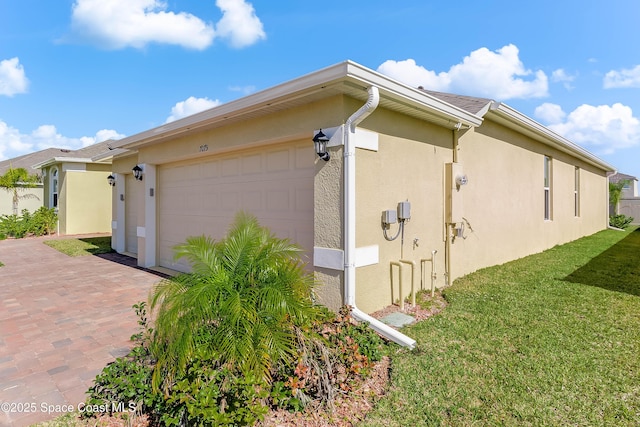 view of property exterior with a garage and a yard