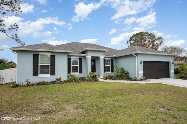 view of front of property featuring a front yard and a garage