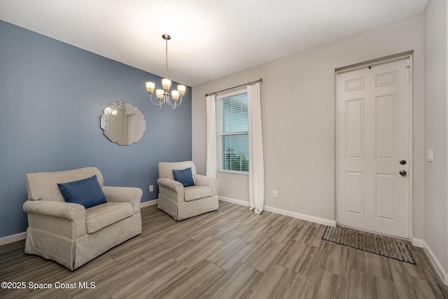 sitting room featuring light hardwood / wood-style floors and a chandelier