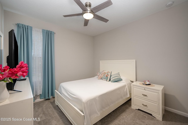 bedroom featuring ceiling fan and carpet