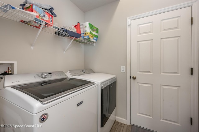 laundry area with separate washer and dryer