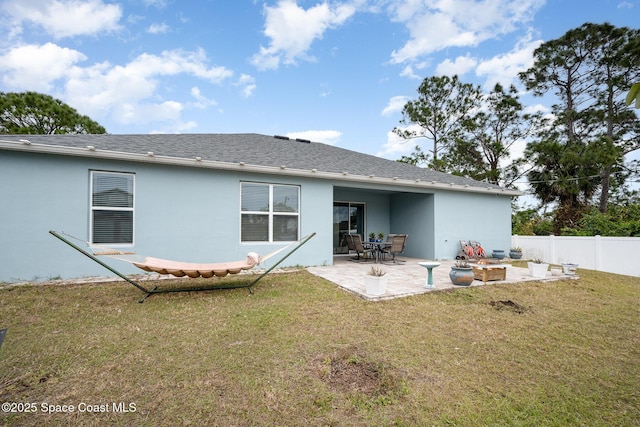 rear view of house with a patio and a yard