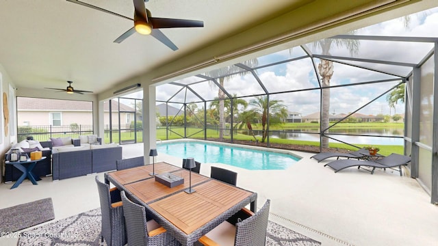 view of swimming pool featuring a lanai, a patio area, outdoor lounge area, and a water view