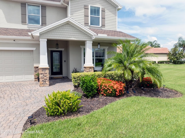 view of front of house with a garage and a front lawn