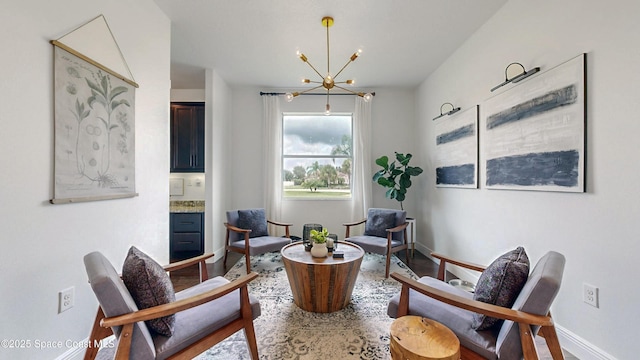 living area featuring hardwood / wood-style floors and a notable chandelier