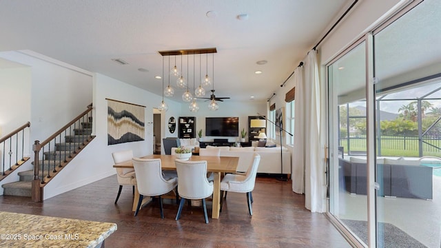 dining area with ceiling fan and dark hardwood / wood-style flooring