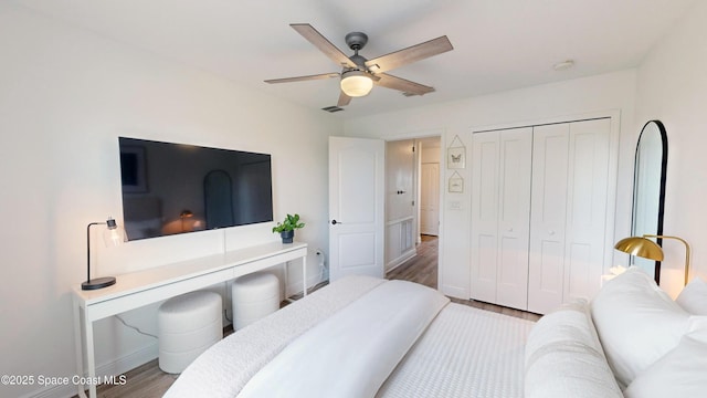 bedroom featuring wood-type flooring, a closet, and ceiling fan