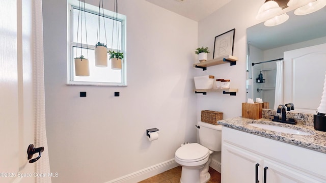 bathroom with curtained shower, vanity, and toilet